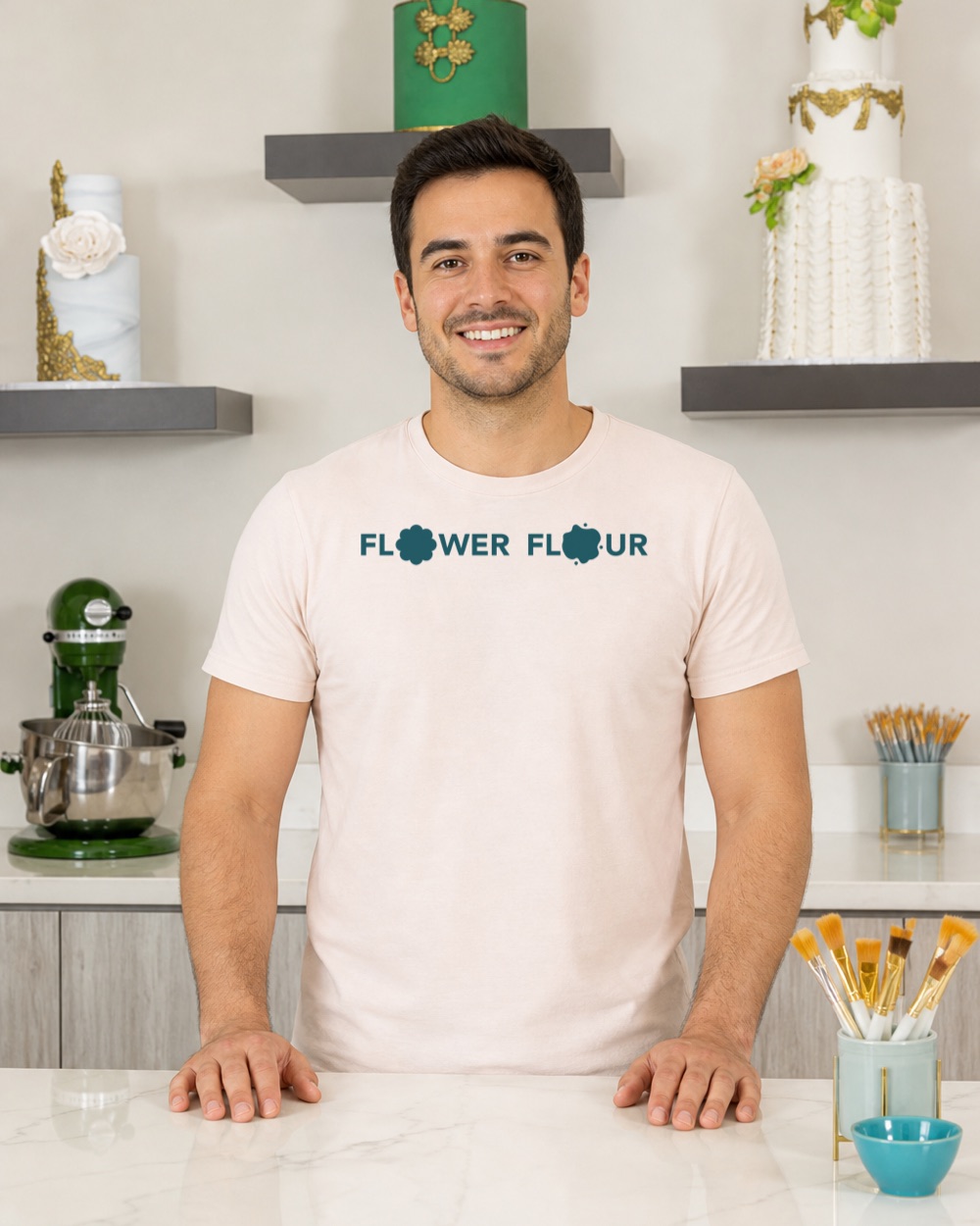Model in the Flower Flour cake studio wearing the blush t-shirt with the teal wordmark