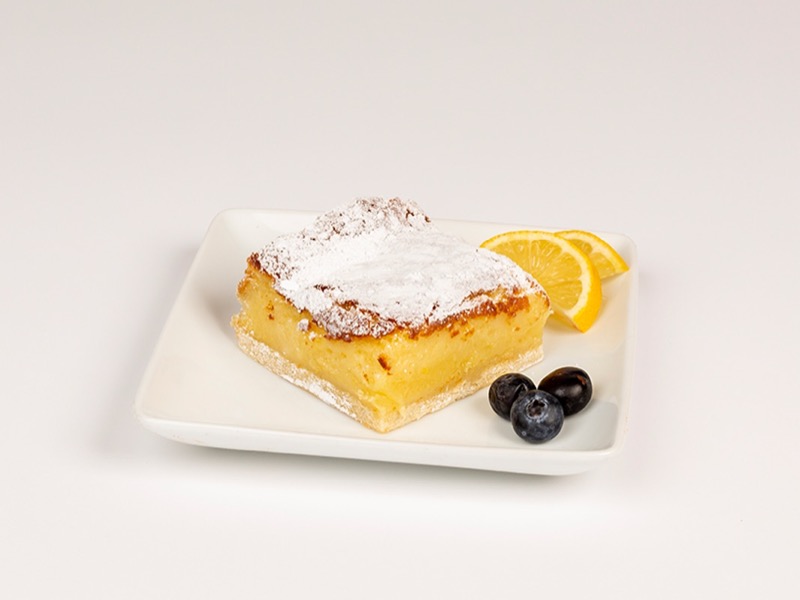 A lemon bar dusted with powdered sugar