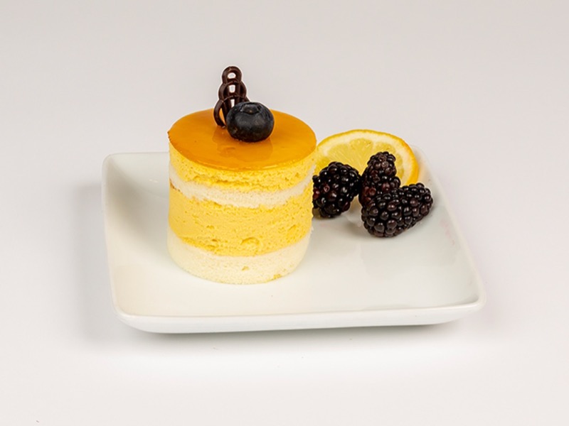 Individual mango tango dessert with a blackberry and chocolate on top
