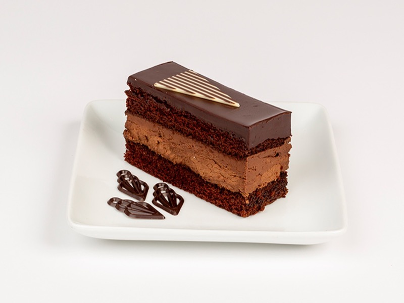 A slice of layered Flower Flour chocolate cake