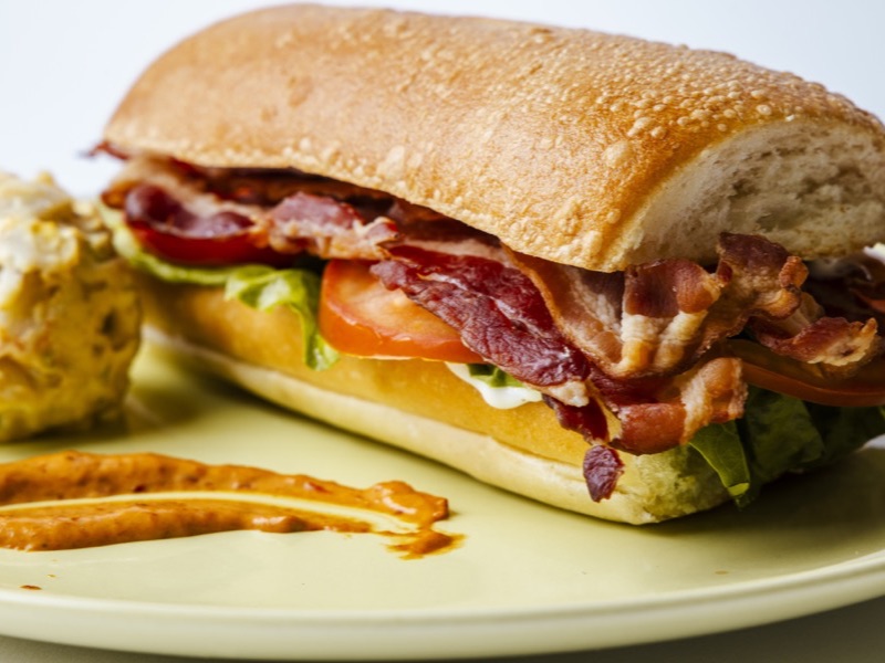 A BLT on a toasted roll with crispy bacon, lettuce, and tomato