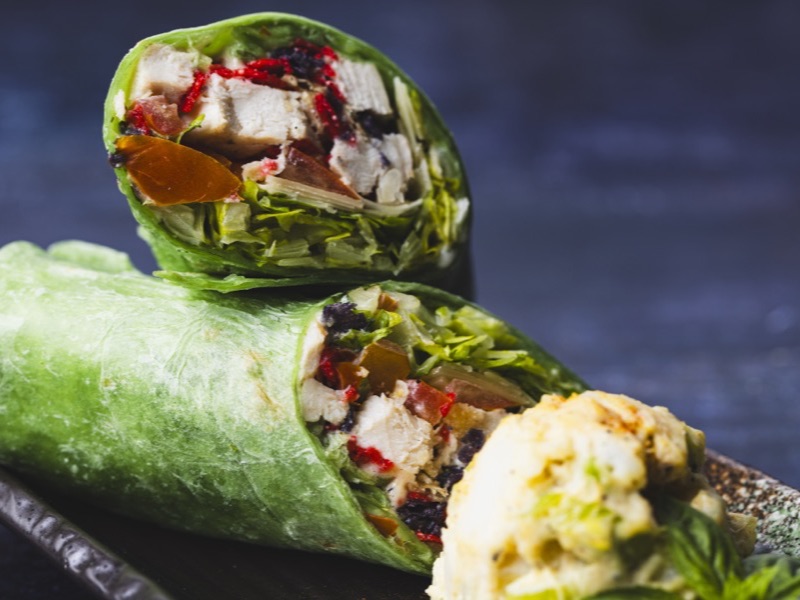 A Caesar chicken wrap cut in half